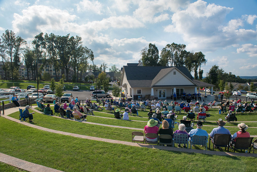 residents in outdoor arena for performance