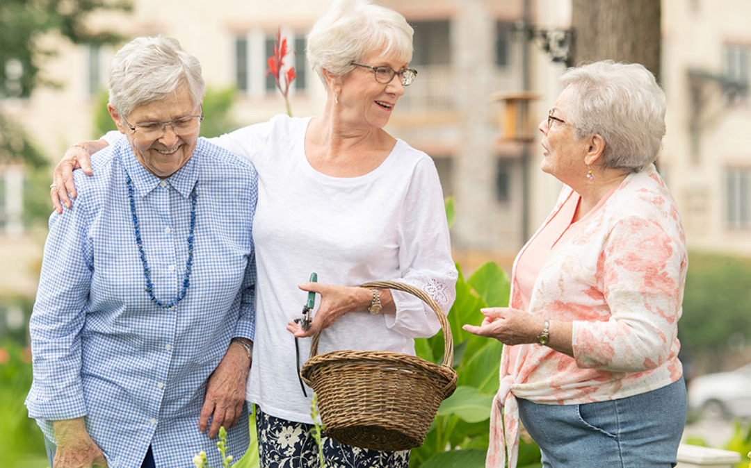 home_ph_1-2 3 ladies in garden chatting<br />